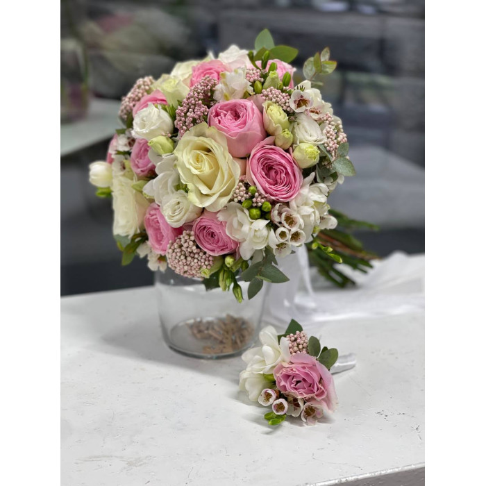 A delicate white and pink bridal bouquet of Mansfield Park peony roses, Mondial roses, white freesia, eustoma, ozothamnus, chamelacium, and eucalyptus (No. 19123)