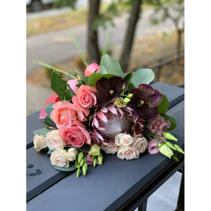 A wedding bouquet of royal protea, chocolate orchid Vanda, delicate roses, eustoma, and eucalyptus (No. 19122)