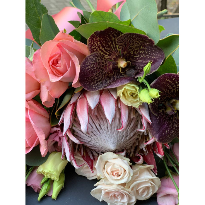 A wedding bouquet of royal protea, chocolate orchid Vanda, delicate roses, eustoma, and eucalyptus (No. 19122)