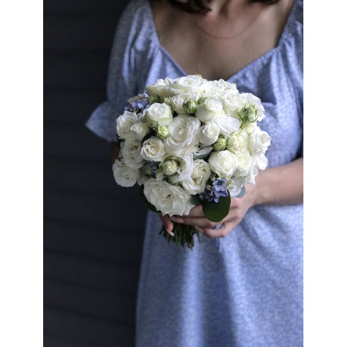 A bridal bouquet of white peony roses accented with blue oxypelatum #12001
